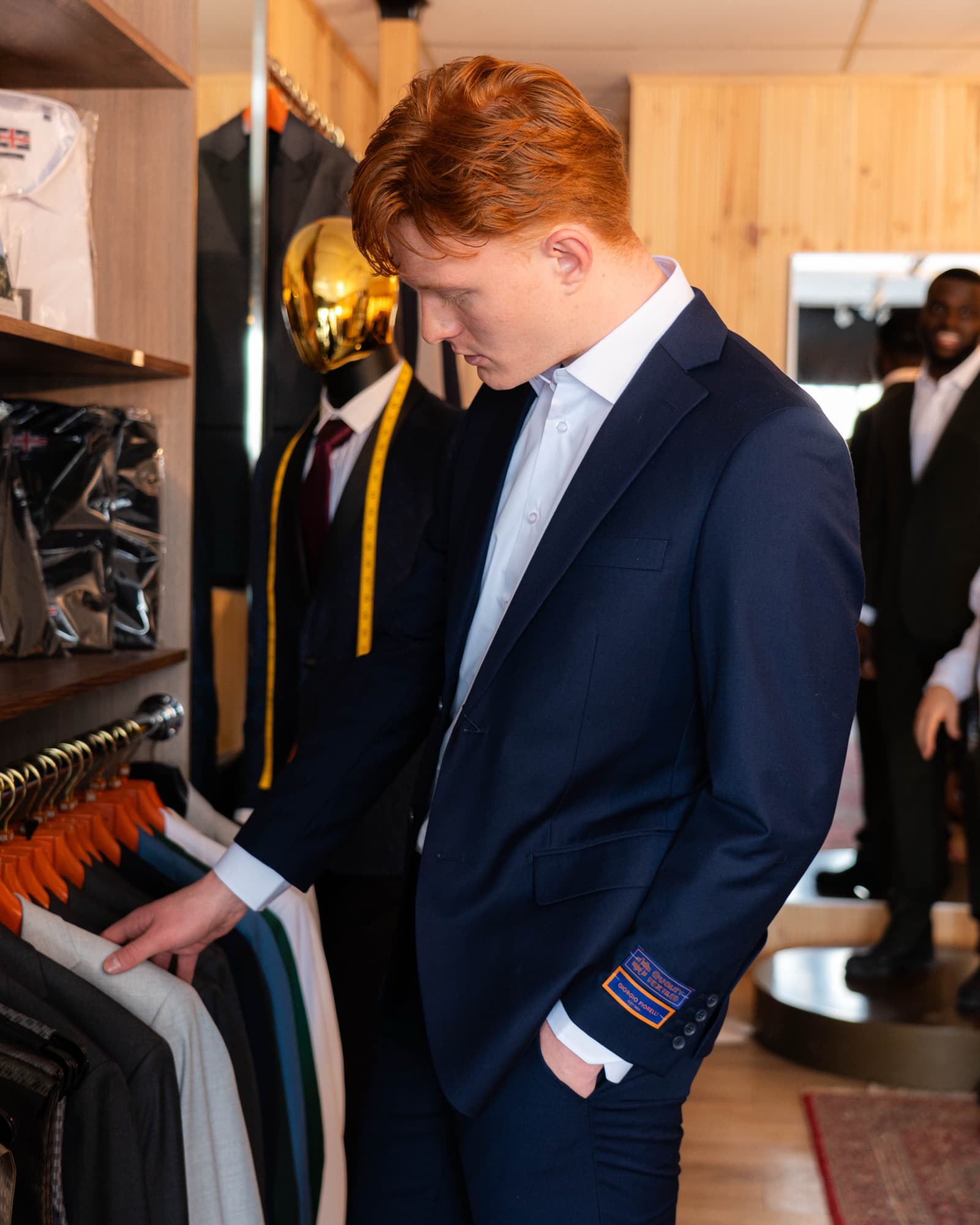 Client browsing the curated suit collection in the boutique