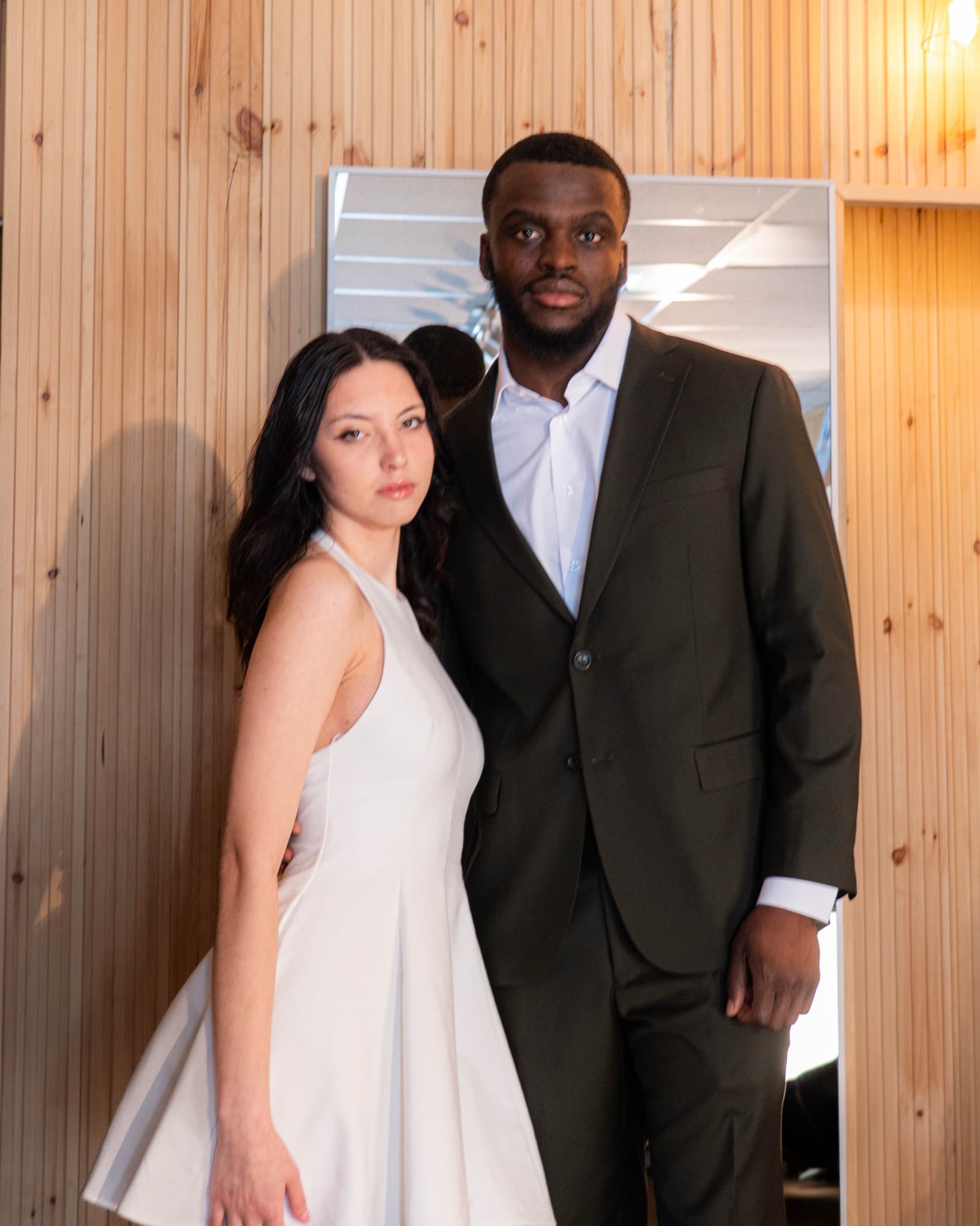 Couple in the boutique — white dress and olive suit
